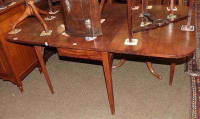Lot 1326 - A 19th century mahogany drop leaf dining table