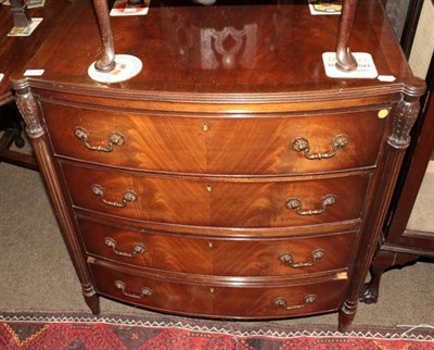 Lot 1338 - A mahogany bow fronted four height chest of drawers, with fluted tapering supports