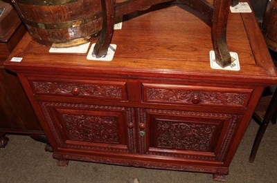 Lot 1351 - A 20th century Chinese hardwood sideboard, with two drawers above two cupboard doors