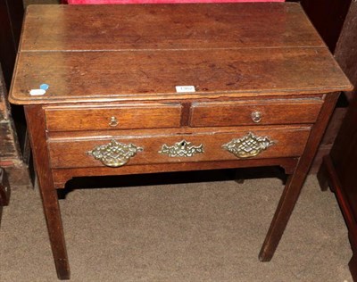 Lot 1362 - A George III provincial oak lowboy