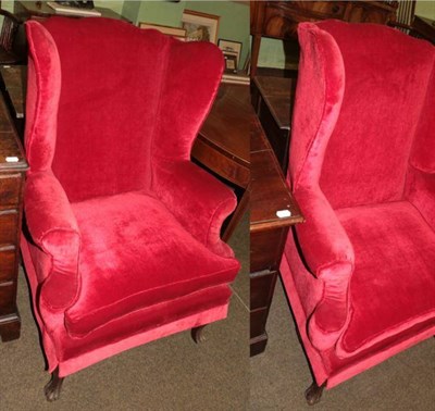 Lot 1368 - A pair of 1920's Georgian style red upholstered wing back armchairs