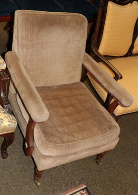 Lot 1380 - A late Victorian open armchair on fluted supports, brass caps and castors