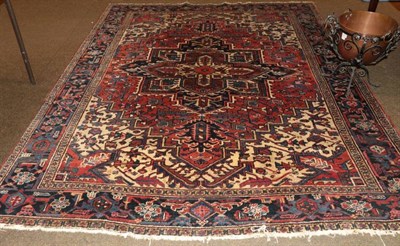 Lot 1382 - Heriz Carpet, Iranian Azerbaijan, circa 1940 The stepped terracotta field of angular vines...