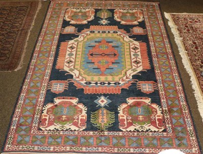 Lot 1385 - West Anatolian village rug, the hooked geometric medallions within conforming narrow borders on...