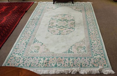 Lot 1392 - Chinese carpet, the pale mint green field with central panel enclosed by apple green borders, 267cm