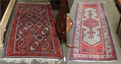 Lot 1395 - A Balouch rug, the field with columns of elephant foot guls, enclosed by stylised vine borders,...