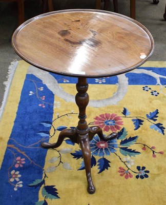 Lot 1422 - A George III mahogany circular dish top tripod table, early 19th century, the baluster vasiform...