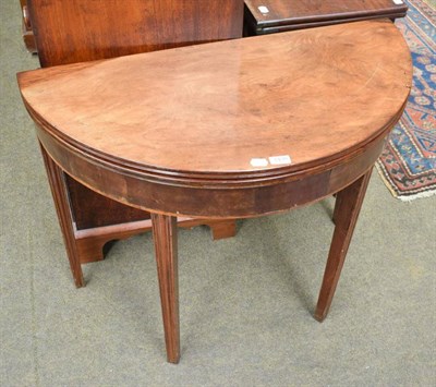 Lot 1430 - A 19th century mahogany demi-lune fold over tea table