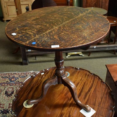 Lot 1437 - A George III circular topped oak tilt top tripod table