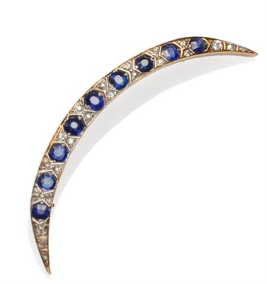 Lot 449 - A Sapphire and Diamond Crescent Brooch, cushion cut sapphires are spaced by pairs of old cut...