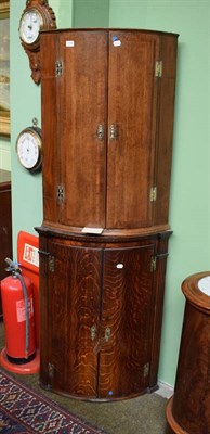 Lot 1452 - Two Georgian oak bow fronted hanging corner cupboards, together with a East Caucasian rug (3)