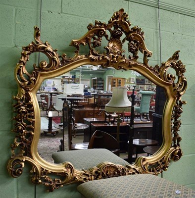 Lot 1456 - A reproduction gilt framed mirror in the rococo taste