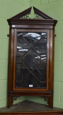 Lot 1459 - An Edwardian inlaid mahogany hanging corner cupboard with astragal glazed door