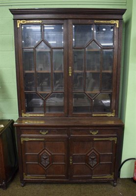 Lot 1468 - A late Victorian oak glazed bookcase cabinet with brass hinges