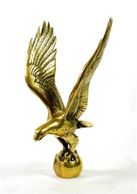 Lot 24 - A Solid Brass Car Mascot, as an American Eagle standing on a rock, 27cm high
