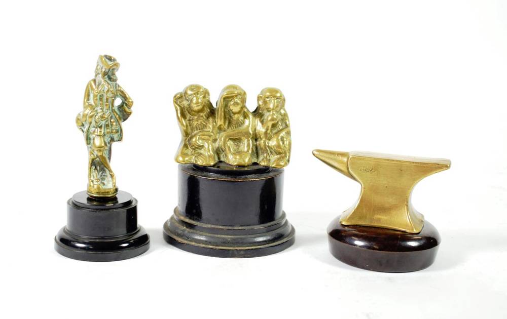 Lot 29 - Three Brass Accessory Mascots, the Gretna Green anvil stamped AEL, 4cm high, a standing mascot as a