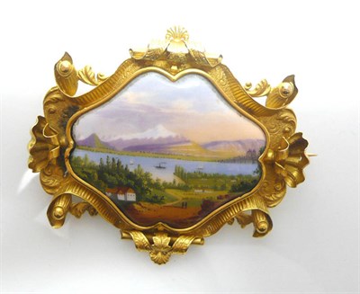 Lot 457 - A Gilt Metal Swiss Enamelled Brooch, depicting a view over the lake to Mont Blanc, in a carved...