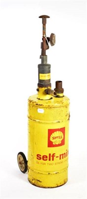 Lot 142 - A Vintage Workshop Portable Oil Canister, on wheels, with yellow cylindrical case and red lettering