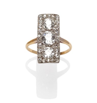 Lot 468 - An Oblong Diamond Cluster Ring, three graduated old cut diamonds pavé set with smaller old...