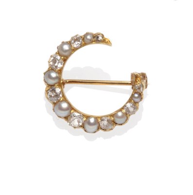 Lot 469 - A Victorian Crescent Brooch, set with graduated alternating split pearls and old cut diamonds,...