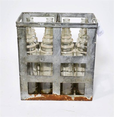 Lot 177 - A Vintage Essolube Metal Cage, containing eight Essolube 1 quart clear glass oil bottles, 37cm...