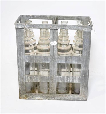 Lot 179 - A Vintage Essolube Metal Cage, containing eight Essolube 1 quart clear glass oil bottles, 37cm...