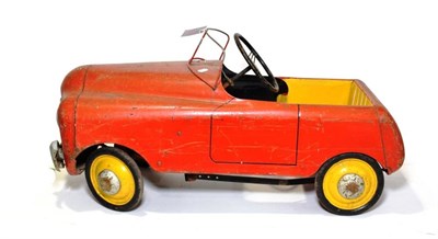 Lot 187 - A 1940's Child's Metal Pedal Car, with a red painted body and curved wind shield, the seat...