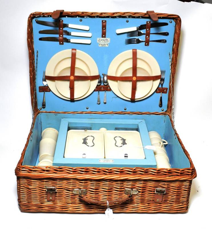 Lot 202 - Fortnum & Mason Ltd: A 1960/70 Coracle Picnic Basket, with hinged lid enclosing a two place setting