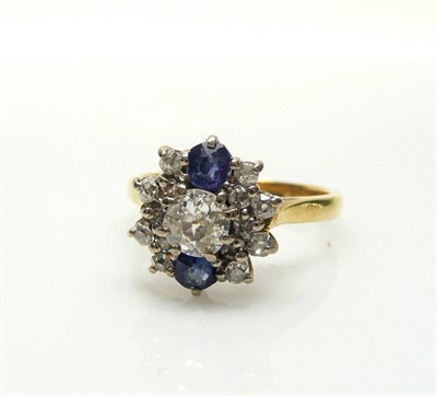 Lot 478 - A Diamond and Sapphire Cluster Ring, old brilliant and eight-cut diamonds in white claw settings to