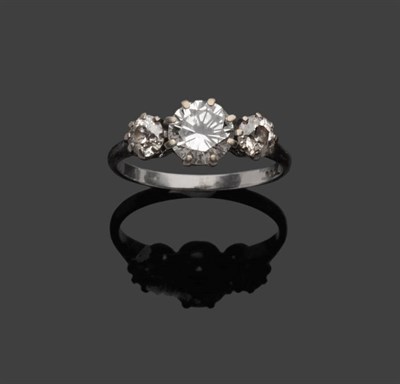 Lot 484 - A Platinum Diamond Three Stone Ring, the graduated round brilliant cut diamonds in white claw...