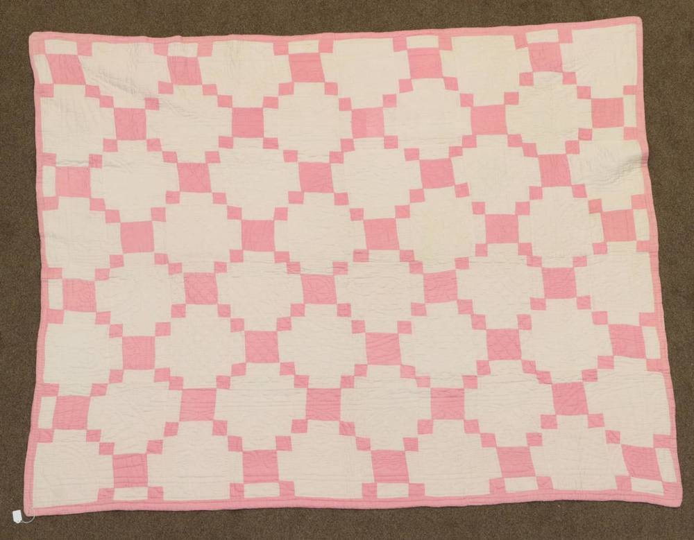 Lot 2046 - Circa 1920s Pale Pink and White Cotton Welsh Quilt, Irish chain pattern patchwork to one side,...