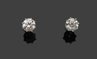 Lot 486 - A Pair of Diamond Solitaire Stud Earrings, the round brilliant cut diamonds held in white eight...