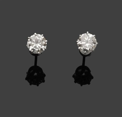 Lot 489 - A Pair of Diamond Solitaire Stud Earrings, the round brilliant cut diamonds held in white eight...