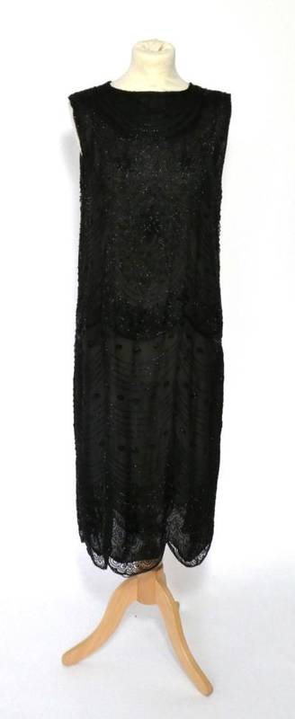 Lot 2117 - Circa 1920s Black Net Shift Dress, with black bugle bead decoration overall in scalloped...