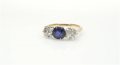 Lot 499 - A Sapphire and Diamond Three Stone Ring, the sapphire flanked by two old brilliant cut diamonds, in