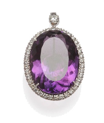 Lot 508 - An 18 Carat White Gold Amethyst and Diamond Pendant, the oval cut amethyst within a border of round