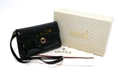 Lot 2283 - Gucci Black Patent Clutch / Shoulder Bag, with hinged circular two-tone metal mount to the flap...