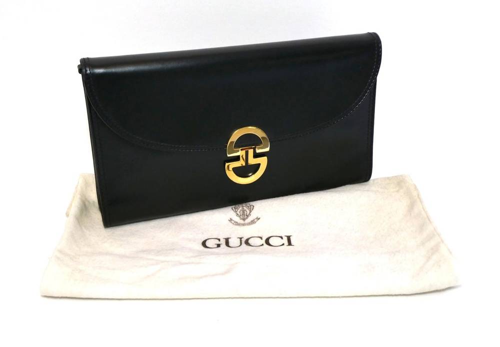 Lot 2284 - Gucci Black Leather Clutch / Shoulder Bag, with detachable strap, the flap closure secured by a...
