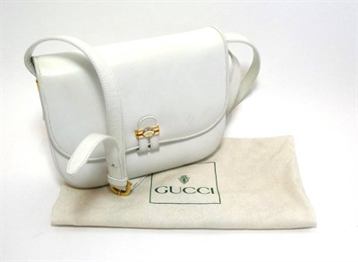 Lot 2288 - Gucci White Leather Shoulder Bag, with adjustable long strap, the flap closure with a two-tone...