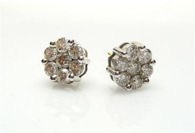 Lot 512 - A Pair of Diamond Cluster Earrings, each stud comprises seven round brilliant cut diamonds in white