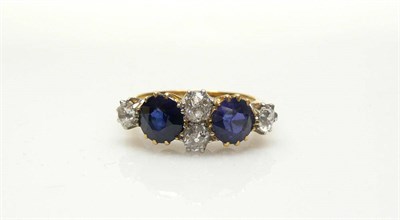 Lot 516 - A Sapphire and Diamond Ring, a pair of old cut diamonds flanked by two round cut sapphires, two...