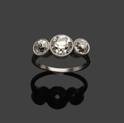 Lot 526 - A Diamond Three Stone Ring, three graduated old cut diamonds, in white millegrain settings to a...