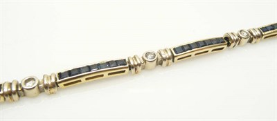 Lot 537 - A Sapphire and Diamond Bracelet, bar links channel set with step cut sapphires are spaced by...