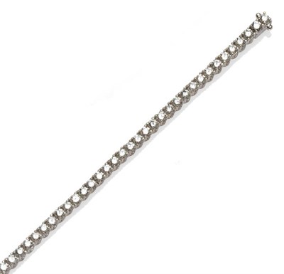 Lot 542 - A Diamond Line Bracelet, forty-four round brilliant cut diamonds in white articulated four claw...