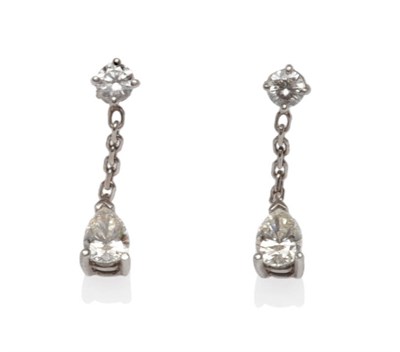 Lot 543 - A Pair of 18 Carat White Gold Diamond Drop Earrings, a round brilliant cut diamond stud...