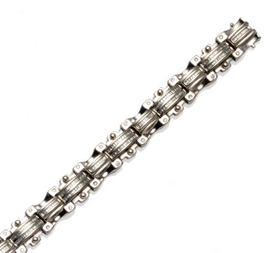 Lot 554 - A 14 Carat White Gold Diamond Bracelet, geometric links set with baguette cut and round...