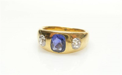 Lot 558 - A Sapphire and Diamond Three Stone Ring, a cushion cut sapphire flanked by two old cut diamonds set