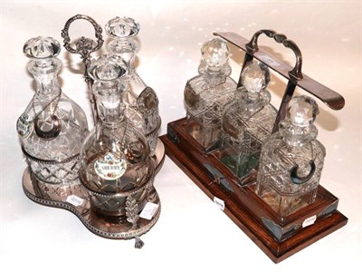 Lot 11 - A silver plated three bottle decanter stand, with cut glass decanters; and a three bottle...