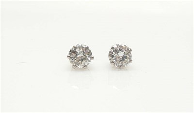 Lot 571 - A Pair of Diamond Solitaire Stud Earrings, each round brilliant cut diamond in a white six claw...