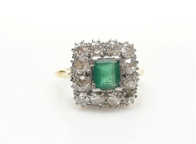 Lot 572 - An Emerald and Diamond Cluster Ring, the step cut emerald within a border of old brilliant cut...